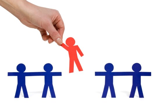 Female hand picking a chosen person from a group